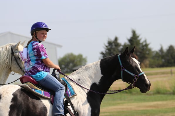 a girl riding on the horse